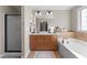 Bright bathroom featuring double sink vanity, soaking tub, and a separate shower enclosure at 323 Windgate Dr, Clayton, NC 27527
