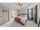Spacious bedroom with trey ceiling, ensuite bathroom, carpet flooring and neutral walls at 323 Windgate Dr, Clayton, NC 27527