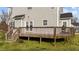 View of the home's wood deck with railing, accessed from doors on the rear of the house at 323 Windgate Dr, Clayton, NC 27527