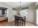 Cozy dining area featuring a square table, seating for four, and natural light from two windows at 323 Windgate Dr, Clayton, NC 27527