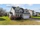 Two-story light-green home with manicured yard and attached two car garage on a sunny day at 323 Windgate Dr, Clayton, NC 27527