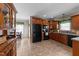 Spacious kitchen features wooden cabinets, tile flooring, and black appliances at 323 Windgate Dr, Clayton, NC 27527