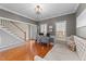 Sunlit living area featuring hardwood floors, neutral paint, and staircase access at 323 Windgate Dr, Clayton, NC 27527