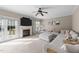 Comfortable living room with a fireplace, large TV, plush seating and ceiling fan at 323 Windgate Dr, Clayton, NC 27527