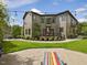 Expansive backyard with a stamped concrete patio, manicured landscaping, and string lights, creating a charming outdoor space at 3315 Denada Path, Durham, NC 27707
