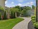 Beautiful backyard with a stamped concrete walkway, manicured landscaping, and a gated entrance, enhancing the outdoor appeal at 3315 Denada Path, Durham, NC 27707