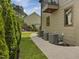 Well-maintained backyard featuring lush greenery, a stamped concrete walkway, and mature trees, perfect for outdoor enjoyment at 3315 Denada Path, Durham, NC 27707