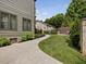 Serene backyard showcasing a stamped concrete walkway, mature landscaping, and privacy, perfect for relaxing or entertaining at 3315 Denada Path, Durham, NC 27707