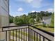 This is a view of the landscape from a balcony with a black metal railing, looking over the neighborhood at 3315 Denada Path, Durham, NC 27707