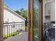 View from a balcony overlooking a fenced-in lawn, with a nearby laundry room visible at 3315 Denada Path, Durham, NC 27707