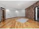 A wide-open basement layout with an accent wall and hardwood flooring at 3315 Denada Path, Durham, NC 27707