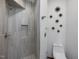 Elegant bathroom featuring a tiled shower with glass door and modern toilet at 3315 Denada Path, Durham, NC 27707