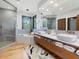 Modern bathroom with double vanity, soaking tub, walk-in shower, and modern fixtures in neutral tones at 3315 Denada Path, Durham, NC 27707