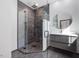 This modern bathroom features a glass shower, unique stone backsplash, and sleek vanity at 3315 Denada Path, Durham, NC 27707