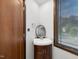 This bathroom has a unique sink, cabinet, and modern style oval mirror at 3315 Denada Path, Durham, NC 27707