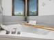 Relaxing bathtub with jets, wine glass, and book, perfect for unwinding after a long day at 3315 Denada Path, Durham, NC 27707