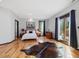 A spacious bedroom with beautiful hardwood floors, area rug, and large windows at 3315 Denada Path, Durham, NC 27707