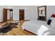 An airy bedroom featuring hardwood floors, modern lighting, and multiple closets at 3315 Denada Path, Durham, NC 27707