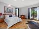 A cozy bedroom with a queen bed, hardwood floors, and outdoor access at 3315 Denada Path, Durham, NC 27707