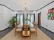 Bright dining room with a glass table, seating for eight, and a modern chandelier at 3315 Denada Path, Durham, NC 27707