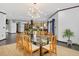 View of the open floor plan to the dining room and kitchen with modern light fixture at 3315 Denada Path, Durham, NC 27707