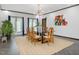 Contemporary dining room features a glass table, seating for eight and stylish light fixture at 3315 Denada Path, Durham, NC 27707