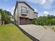 Modern home boasts a two-car garage, fenced yard, and a balcony off of the top floor at 3315 Denada Path, Durham, NC 27707