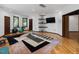 Light-filled fitness room with hardwood floors, built-in shelving, and space for exercise at 3315 Denada Path, Durham, NC 27707