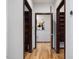 Hallway featuring a light-colored hardwood floor and doors to two walk-in closets and an additional room at 3315 Denada Path, Durham, NC 27707