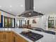 Modern kitchen features stainless steel hood and marble countertops and a view to dining room at 3315 Denada Path, Durham, NC 27707