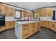 A bright kitchen features wooden cabinets, a white backsplash, and a marble island at 3315 Denada Path, Durham, NC 27707