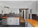 A cozy kitchen features custom cabinets, butcher block countertops, and modern appliances at 3315 Denada Path, Durham, NC 27707