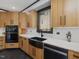 Kitchen featuring wooden cabinets, a farmhouse sink, and white countertops and backsplash at 3315 Denada Path, Durham, NC 27707