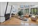 Bright living room with hardwood floors, fireplace, and many windows at 3315 Denada Path, Durham, NC 27707