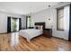 Bright bedroom with hardwood floors, a queen bed, and two windows with dark trim and white curtains at 3315 Denada Path, Durham, NC 27707