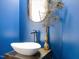 Stylish powder room with a vessel sink, modern faucet, and peacock feather decor at 3315 Denada Path, Durham, NC 27707