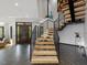 Staircase featuring wood steps and black metal railings near a wood front door at 3315 Denada Path, Durham, NC 27707
