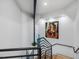 Close up of the modern staircase with an interesting piece of artwork at the top of the stairs at 3315 Denada Path, Durham, NC 27707