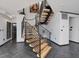 Modern staircase with wood steps and black metal railings adjacent to the front entrance at 3315 Denada Path, Durham, NC 27707
