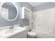 Bathroom features a vanity, toilet, and shower/tub combination with blue walls at 3325 Tarleton E, Durham, NC 27713