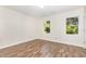 Bright bedroom featuring hardwood floors, neutral walls, and windows for natural light at 3325 Tarleton E, Durham, NC 27713