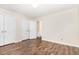 Bedroom showing hardwood floors, double closets, neutral walls, and a view into the hall at 3325 Tarleton E, Durham, NC 27713
