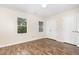 Bedroom view showcasing hardwood floors, closet, and windows for natural light at 3325 Tarleton E, Durham, NC 27713