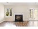 Living room area with fireplace, natural light and door that lead to deck at 3325 Tarleton E, Durham, NC 27713