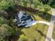 Beautiful aerial shot of a bright home on a well-manicured lawn surrounded by dense trees at 40 Ridgeline Ct # 10, Pittsboro, NC 27312