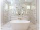 Bathroom showcasing soaking tub with marble walls, rainfall shower, and gold fixtures at 40 Ridgeline Ct # 10, Pittsboro, NC 27312