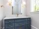 Bathroom with blue vanity with granite countertops, gold fixtures, and large mirror at 40 Ridgeline Ct # 10, Pittsboro, NC 27312
