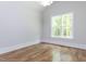 Bright, airy bedroom with hardwood floors, neutral walls, large window, and a modern lighting fixture at 40 Ridgeline Ct # 10, Pittsboro, NC 27312