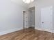 Spacious bedroom featuring hardwood floors, large window, modern doors, and a view to hallway at 40 Ridgeline Ct # 10, Pittsboro, NC 27312