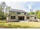 A lovely backyard featuring a well-maintained lawn, a covered patio, and a modern grill at 40 Ridgeline Ct # 10, Pittsboro, NC 27312